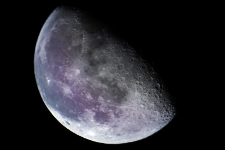 About us. A image of a half moon with purple hues